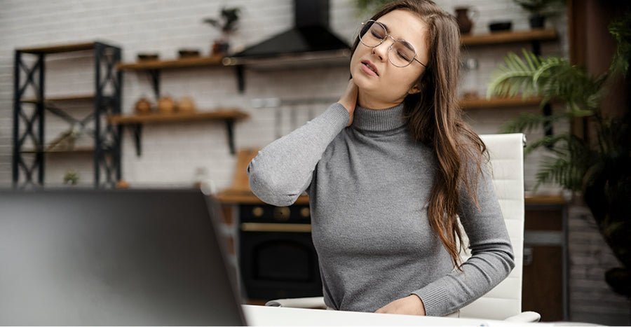 Woman in gray turtleneck demonstrating safe neck relief