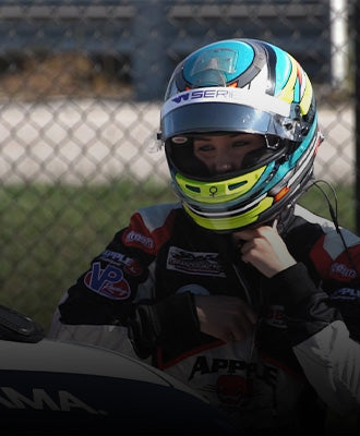 Sabre cook putting on her racing helmet.