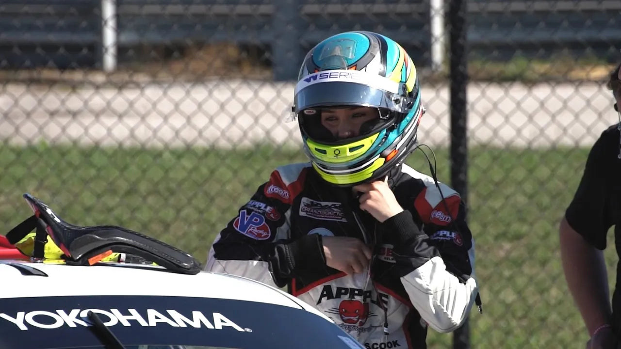 Sabre Cook putting on her helmet before a race
