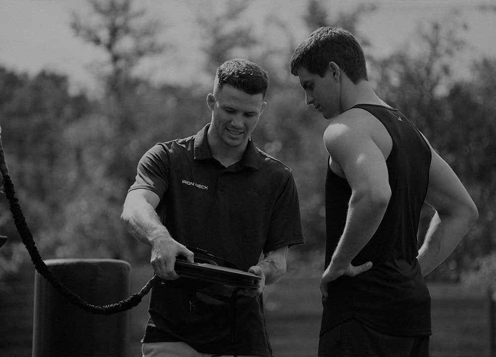 Iron Neck Trainer showing athlete how to use Iron Neck 
